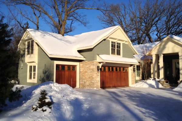 A professional fire and smoke restoration house with snow on the ground.