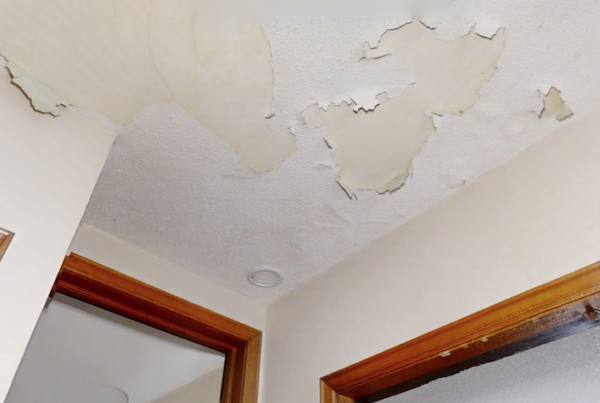 Ceiling water damage showing peeling paint and water damage.