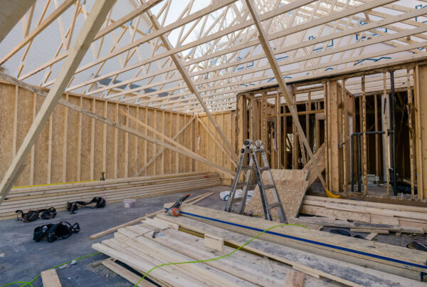 The construction site on Dublin Road showcases wooden framing for a house, with a ladder, tools, and scattered lumber under the partially constructed roof, hinting at an ambitious kitchen remodel.